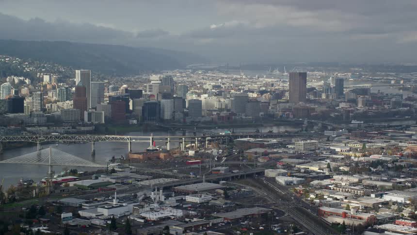 On a cloudy day a city view with lots of high rise buildings