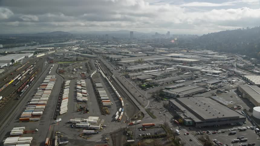Aerial panorama of a logistics center with trains containers on a cloudy day with clouds