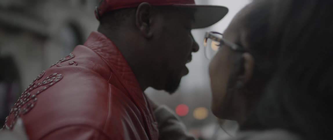 A man is talking then hugs a woman