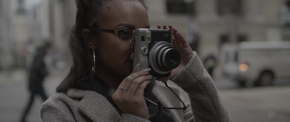 A woman is taking photographs on a very windy day