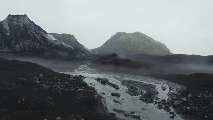 An aerial view of a river winding through a glacier