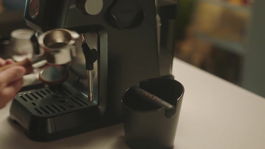 A person is filling the coffee machine