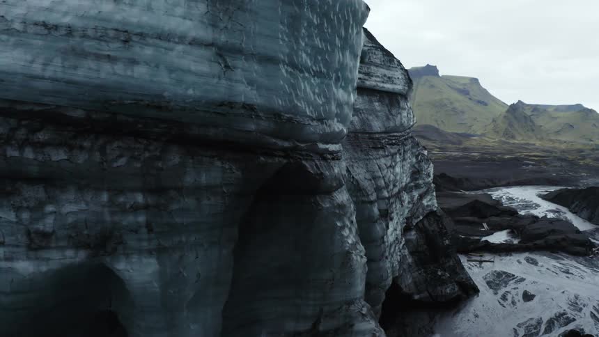 Rocky mountain ranges with rivers of frozen water while it rains