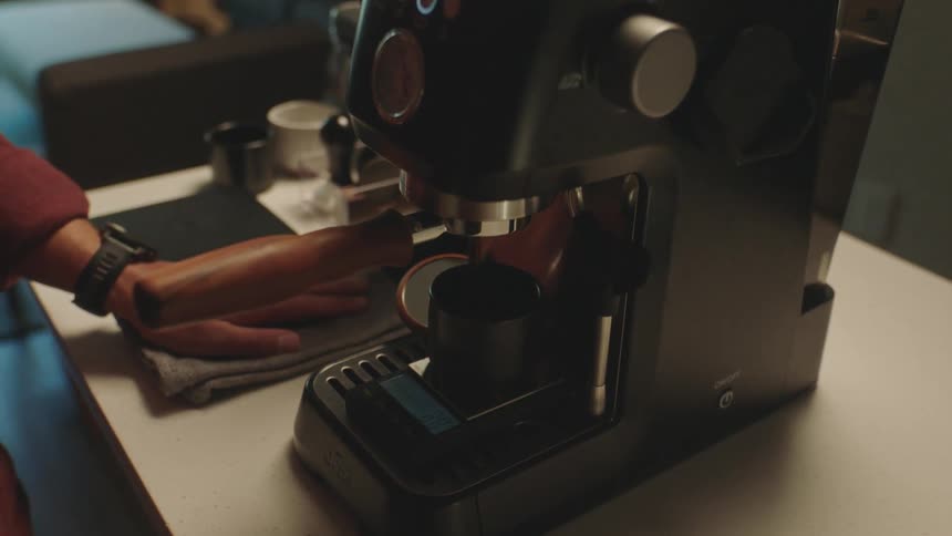 Closeup of a machine preparing espresso coffee