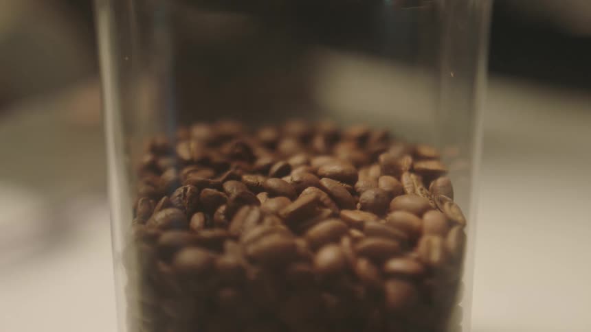 Close up of coffee beans in a glass jar