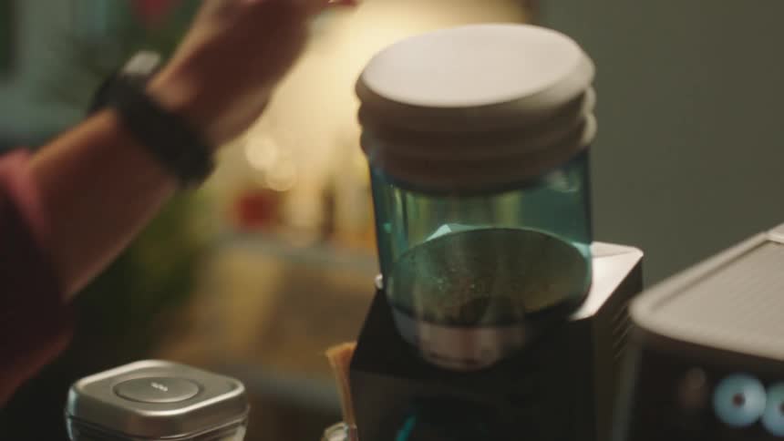 Closeup of a mans hands making coffee with a machine
