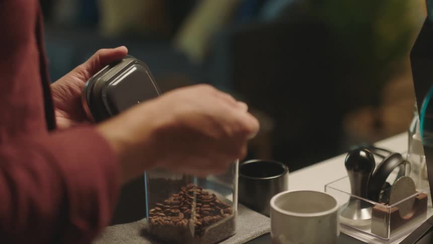 A person is preparing coffee with a machine