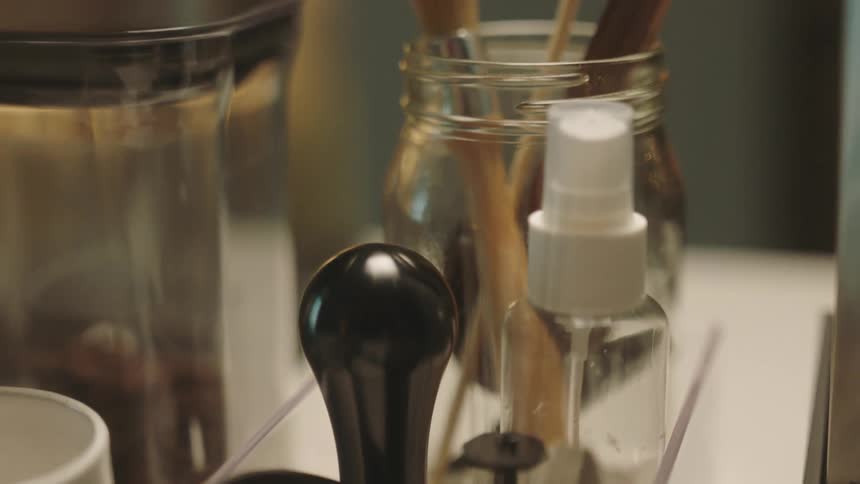 Makeup and brushes are in the bathroom