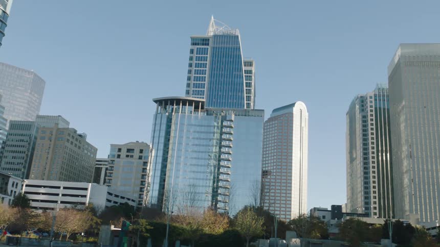 Panorama of modern mirrored skyscrapers in a metropolis on a clear cloudless blue sky day