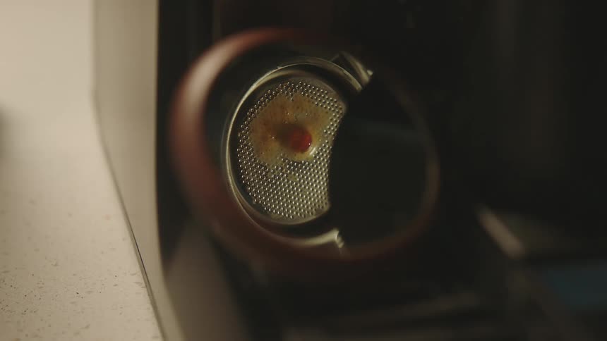 The coffee machine is brewing coffee