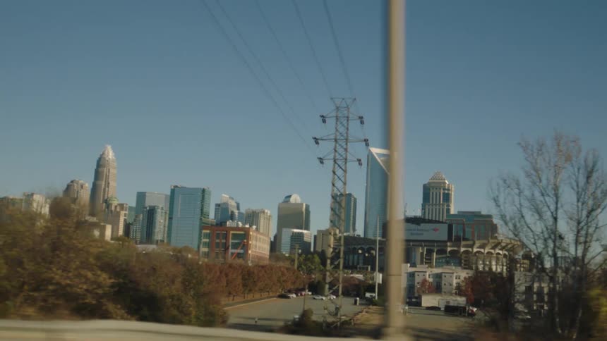 An urban city with skyscrapers seen from a moving car