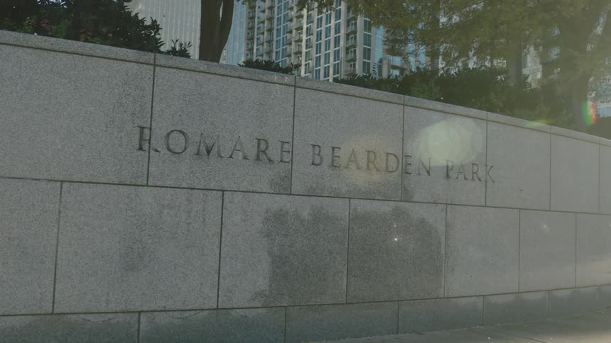 A concrete wall with phrases written in the urban city
