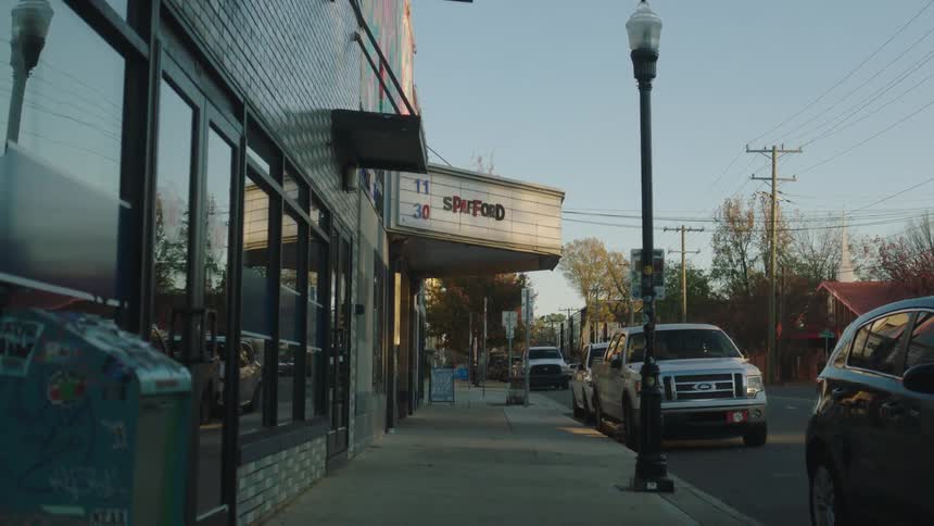 View of the sidewalk next to a building in the morning