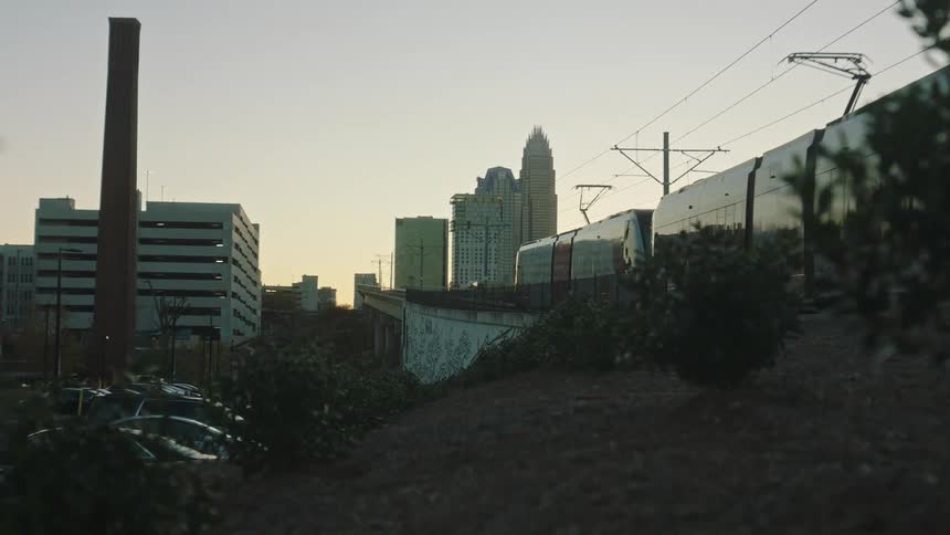 Train departing from the city at morning