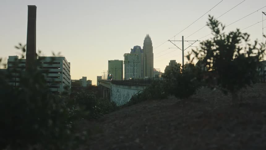 A train passing over a bridge in the urban city