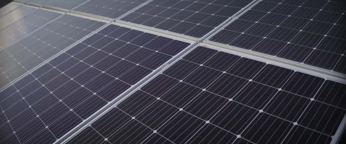 Sunlight shines on the solar panels on a building