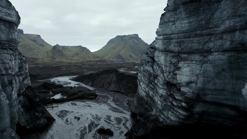 Aerial of the river between mountain ranges during the day