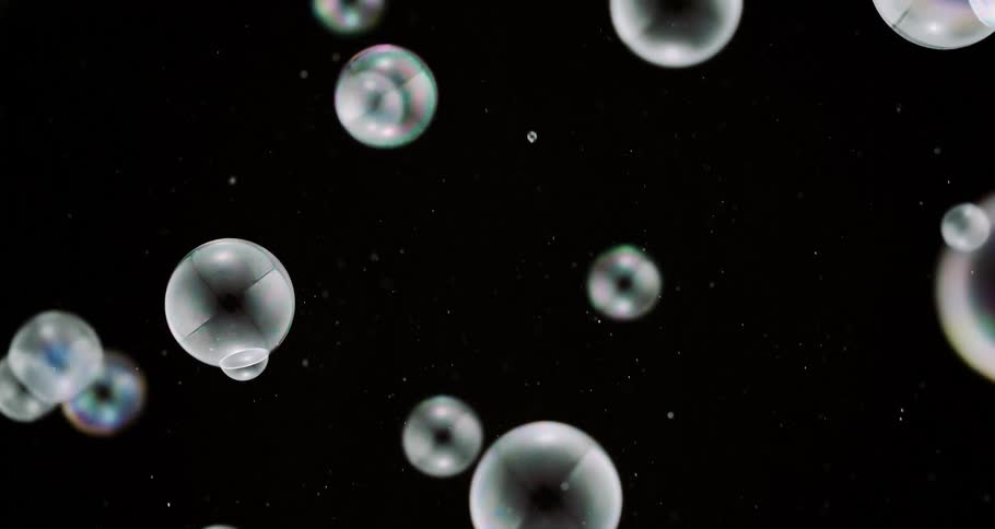 Shimmering soap bubbles float in the air
