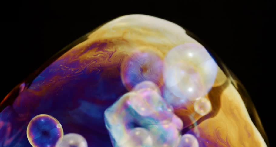 Extreme closeup on a water bubble with smaller bubbles inside in slow motion