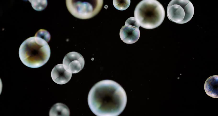 Colorful bubbles falling in slow motion