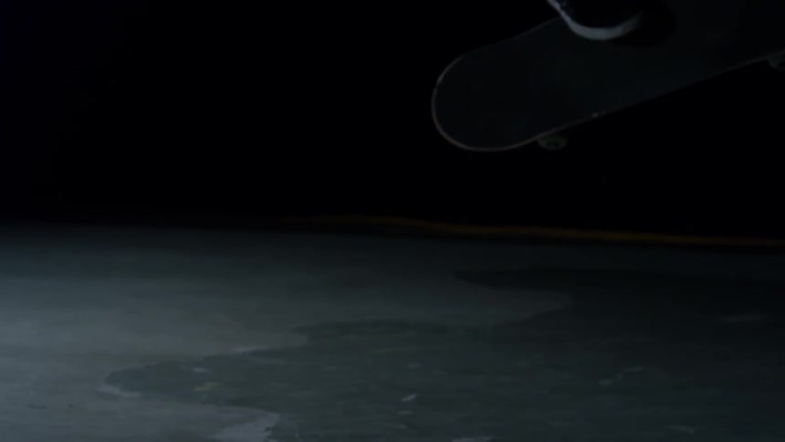 Closeup on the legs of a person skateboarding in slow motion