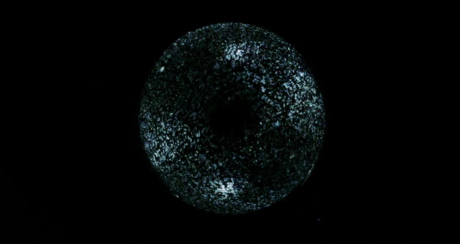 A reflective orb floats in the dark