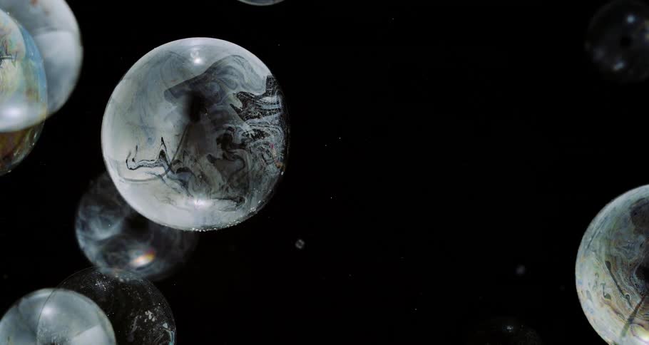 Several soap bubbles on a black background