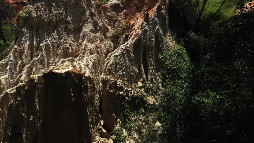 View of a cave in the midst of nature with sunlight reflection