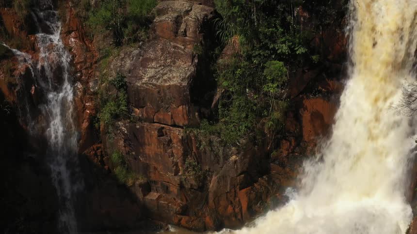 A strong waterfall on a mountain on a sunny morning