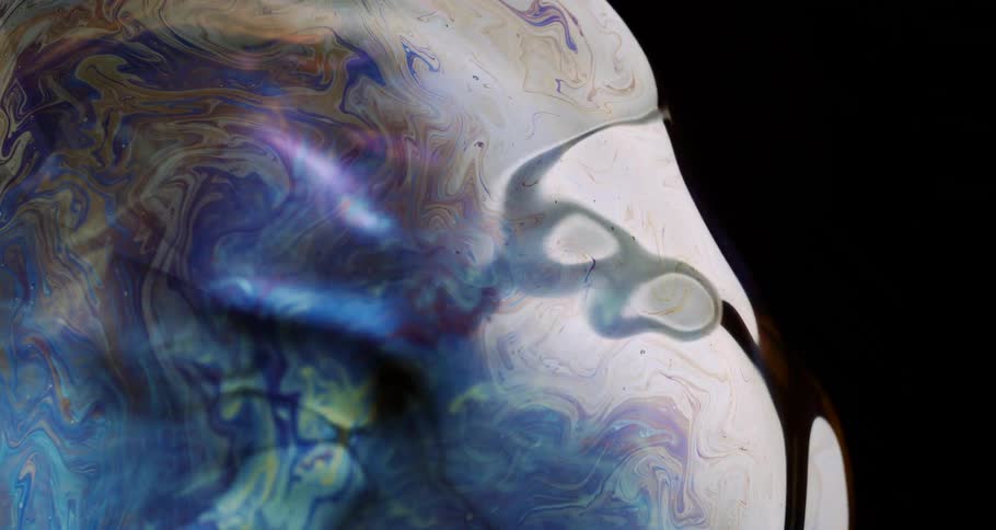 Iridescent patterns form on oily surface reflecting white object