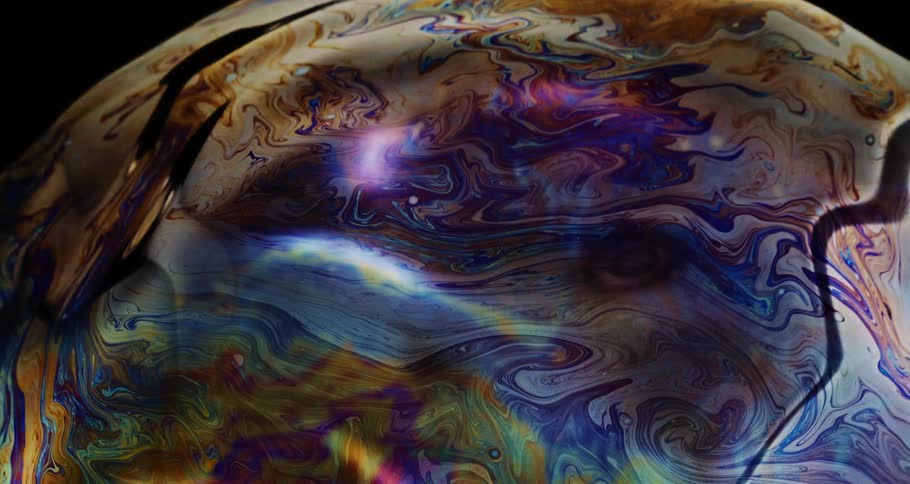 Shimmering ripples on the surface of a large soap bubble