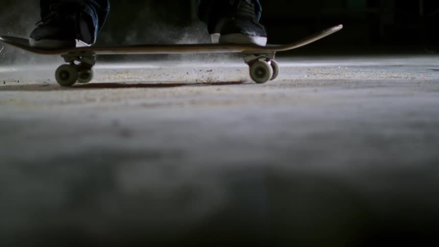 A person skidding on a skateboard