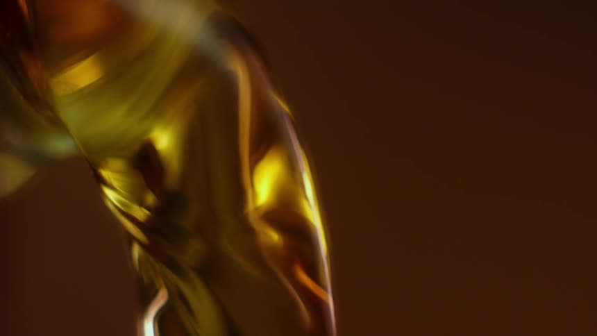 Browning liquid falling from a bottle in slow motion