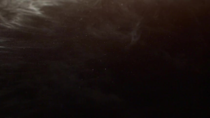 Extreme closeup of abstract brown powder in slow motion