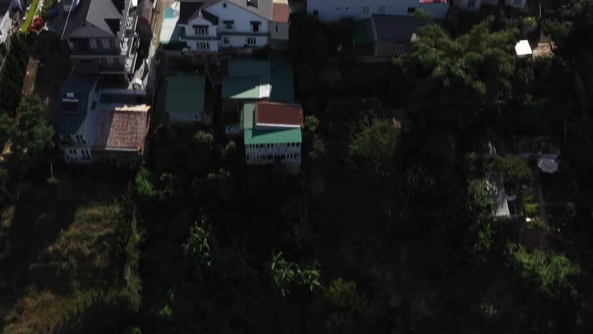 Homes are all over the green hills