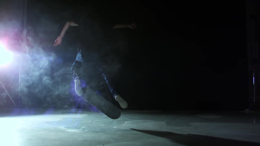 Man jumping and performing a skateboard trick in slow motion
