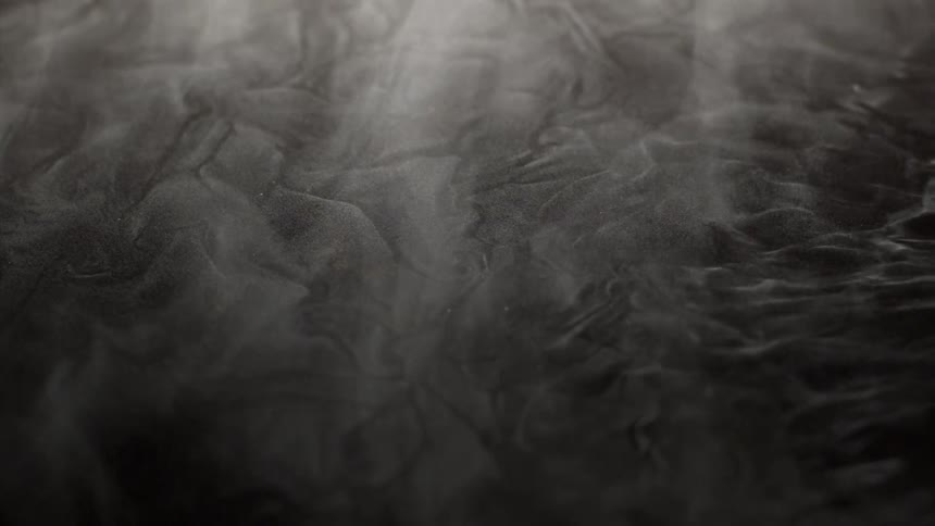 White smoke on the ground that moves to the left with the wind