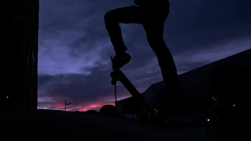 Man skateboarding at night in slow motion
