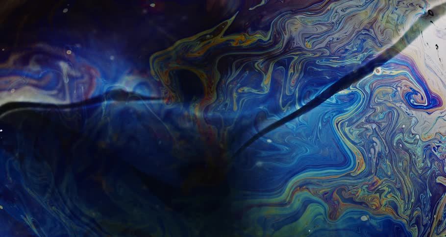 Microscopic view of a water bubble with colorful blue textures in slow motion