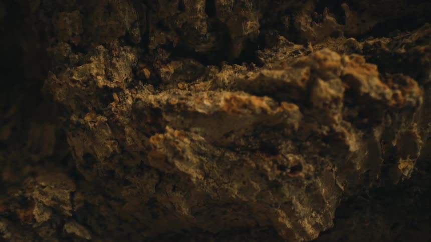 Close up of multi layered roughly textured surface colored shades of tan and brown