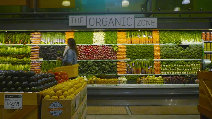 A woman walks in a grocery store