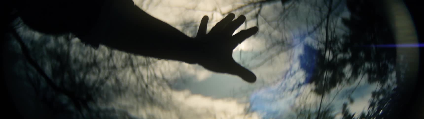 A person puts his hand up blocking the sun briefly