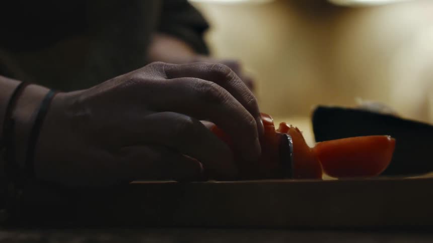 A person is cutting a tomato