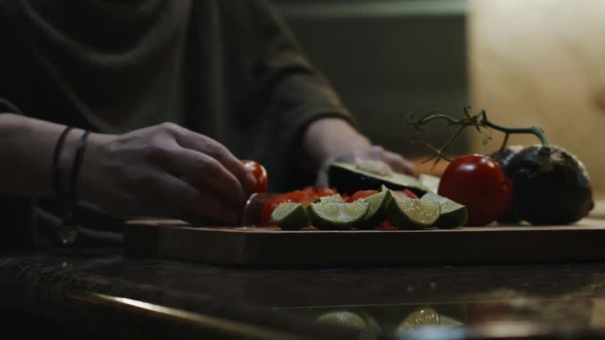 A person is preparing some food on a board