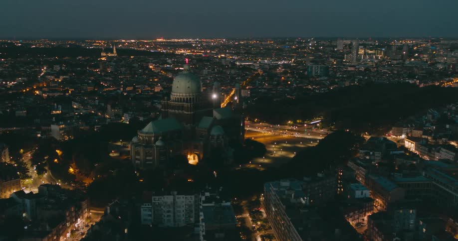 Aerial panorama of a temple in the center of a city at night