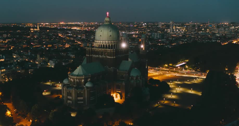 Aerial of a catholic church with classical architecture at night in the city