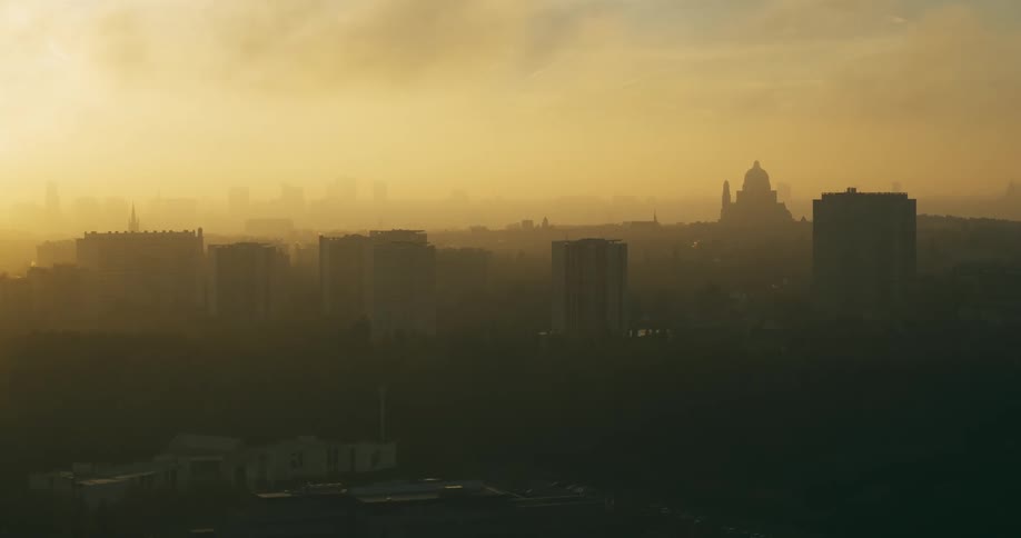 Aerial of an urban city covered in fog during dawn