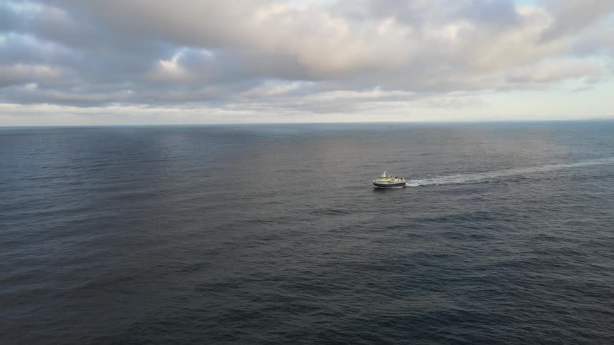 An aerial view of a boat floating on water