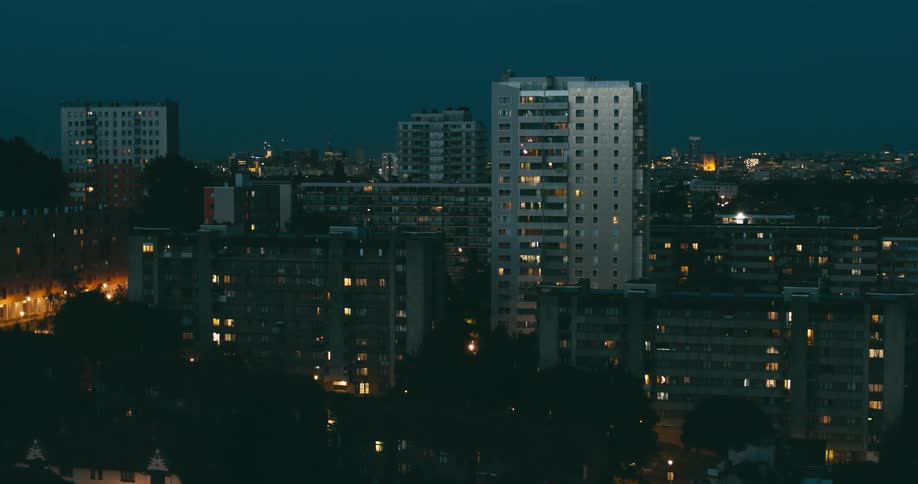 Aerial view of illuminated apartment buildings in the evening