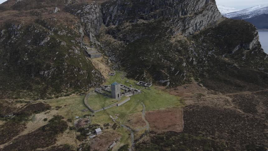 Castle tower and fortress beside mountains on an island